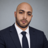 Yacine Belkadi in a navy business suit